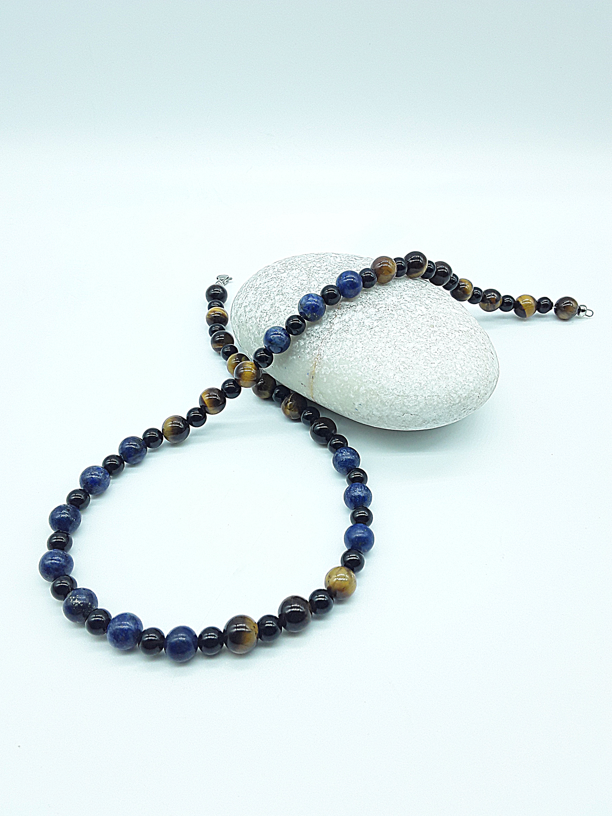 Polmadeva Quiet Sentinel Necklace with lapis lazuli, tiger’s eye and black onyx beads forming looped composition around natural stone, Guardian Spirit collection