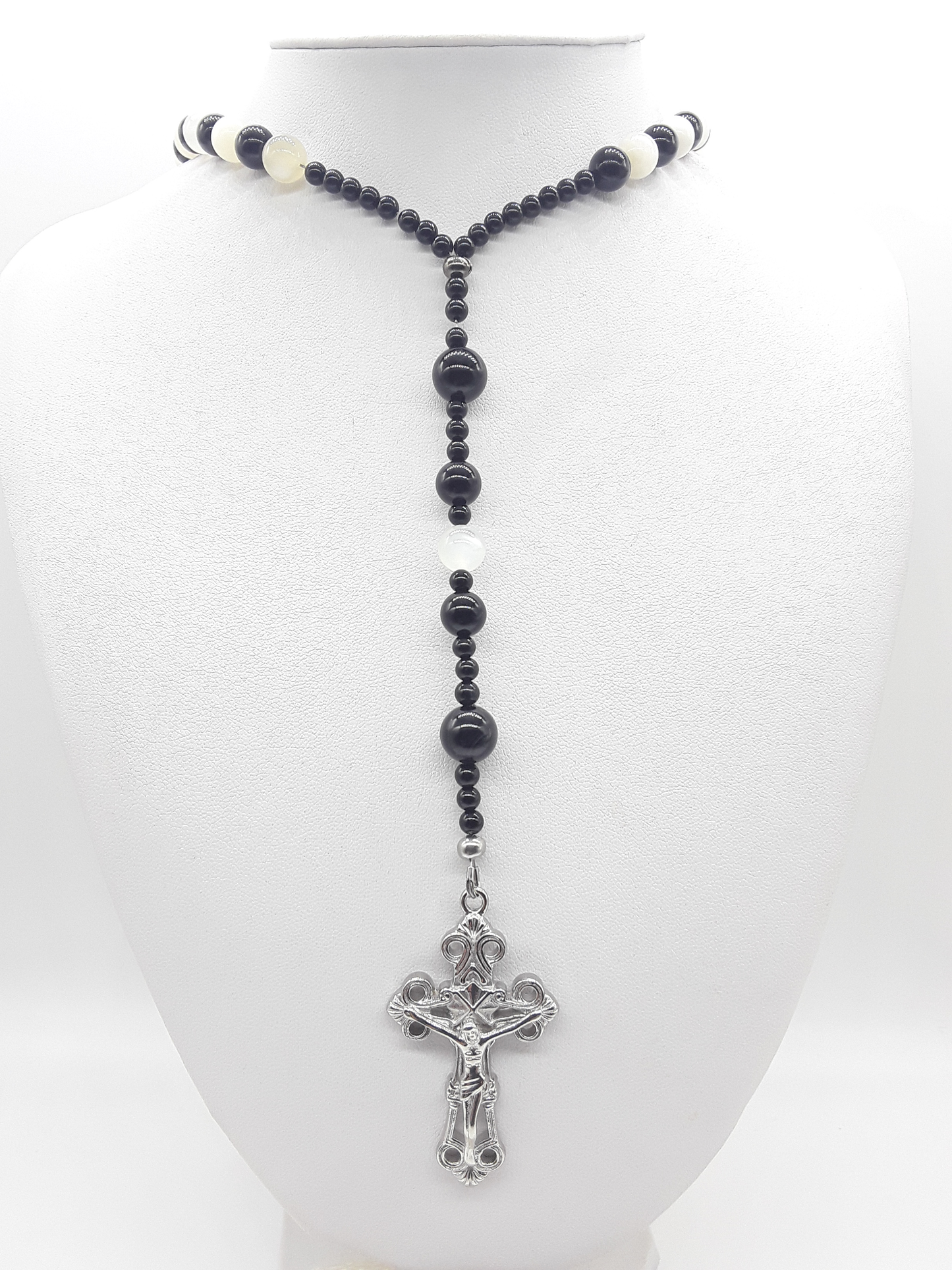 Black Onyx and Moonstone Catholic rosary with a stainless steel crucifix displayed on a mannequin bust