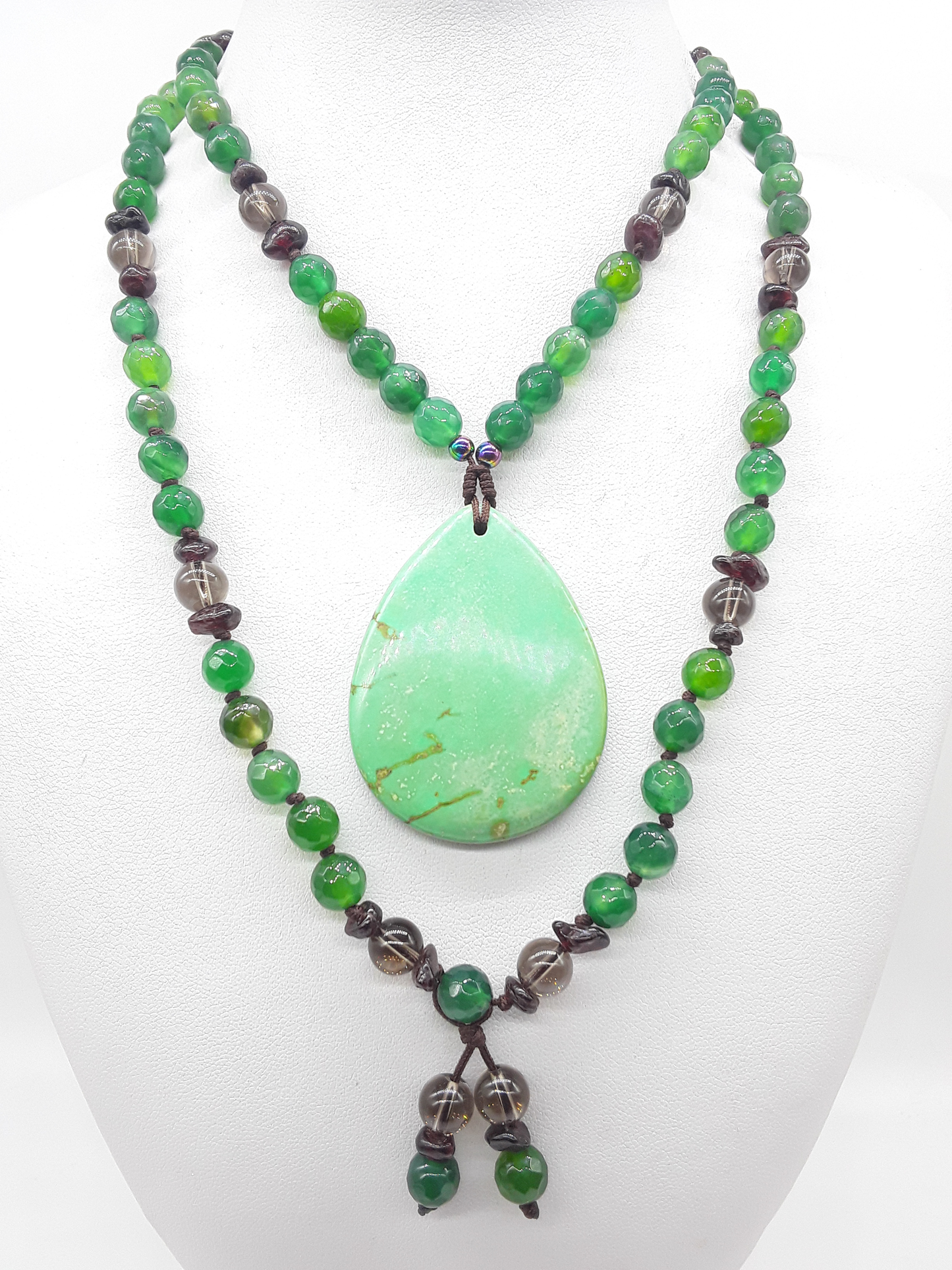 Agate and Smoky Quartz Mala Beads arranged in flowing form with teardrop Agate pendant on white background, Polmadeva