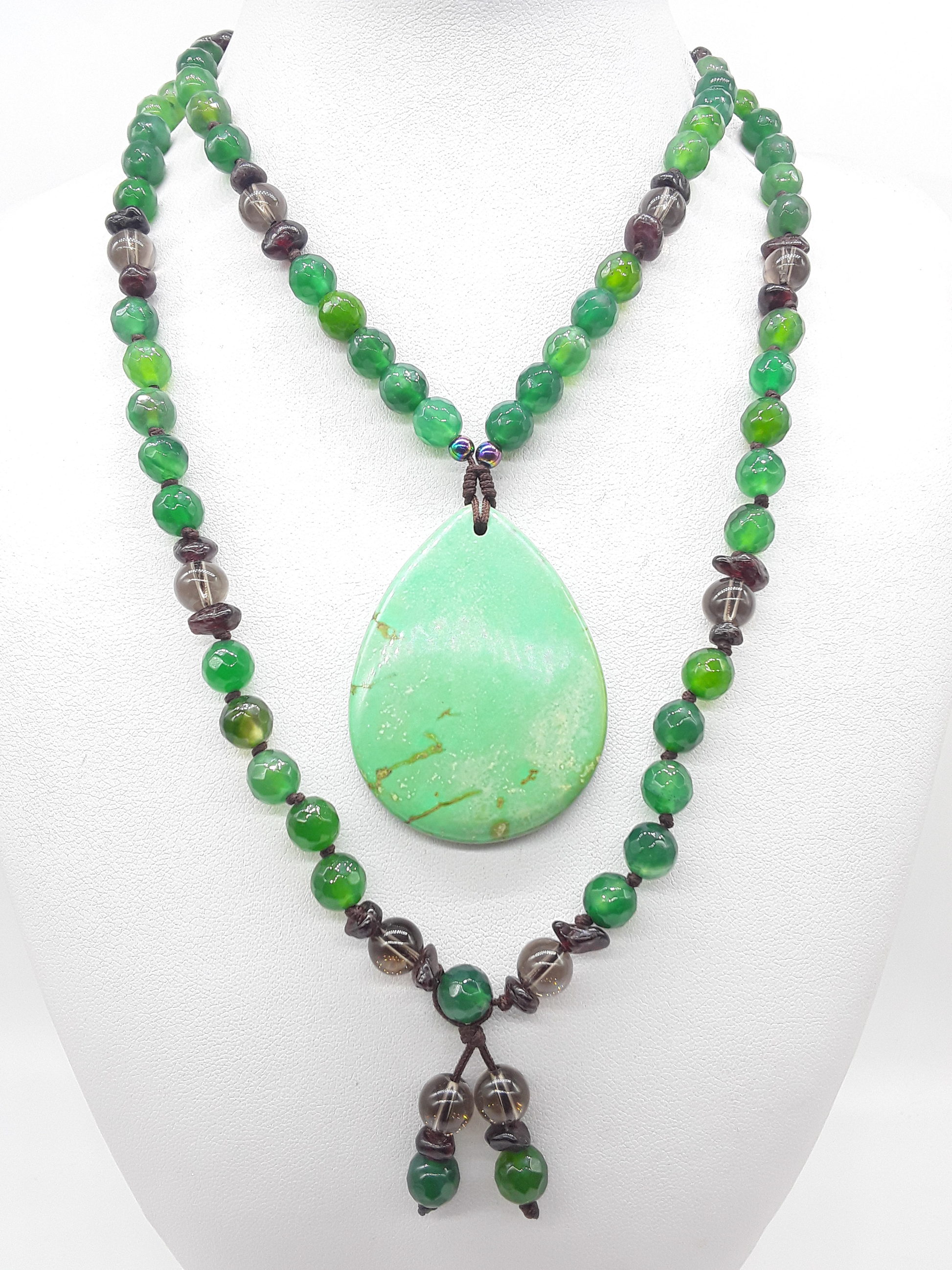 Agate and Smoky Quartz Mala Beads arranged in flowing form with teardrop Agate pendant on white background, Polmadeva