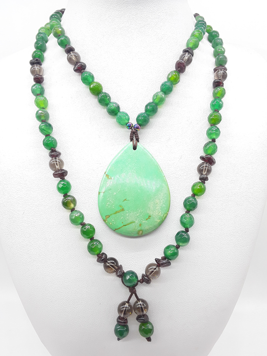 Agate and Smoky Quartz Mala Beads arranged in flowing form with teardrop Agate pendant on white background, Polmadeva