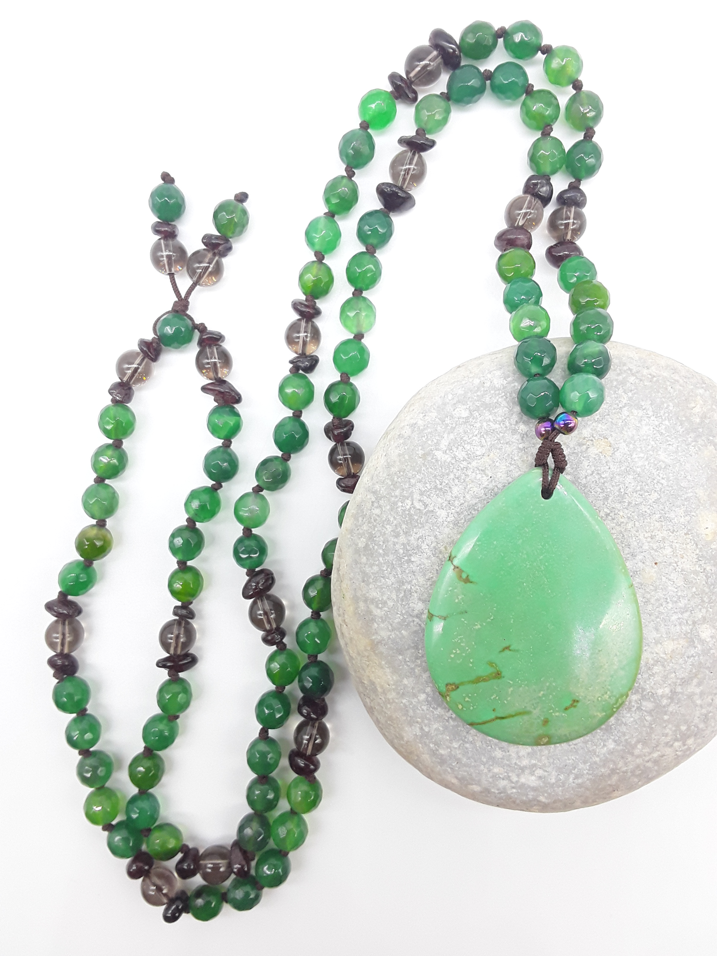 Agate and Smoky Quartz Mala Beads with teardrop Agate pendant placed on stone on white background, Polmadeva