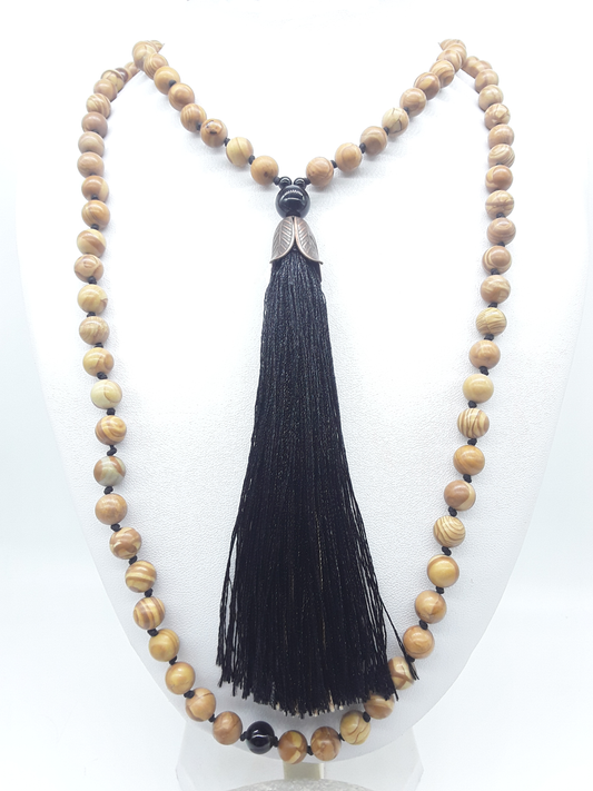 Tigerskin Jasper Mala Beads with Black Onyx elements and tassel displayed on white background, Polmadeva