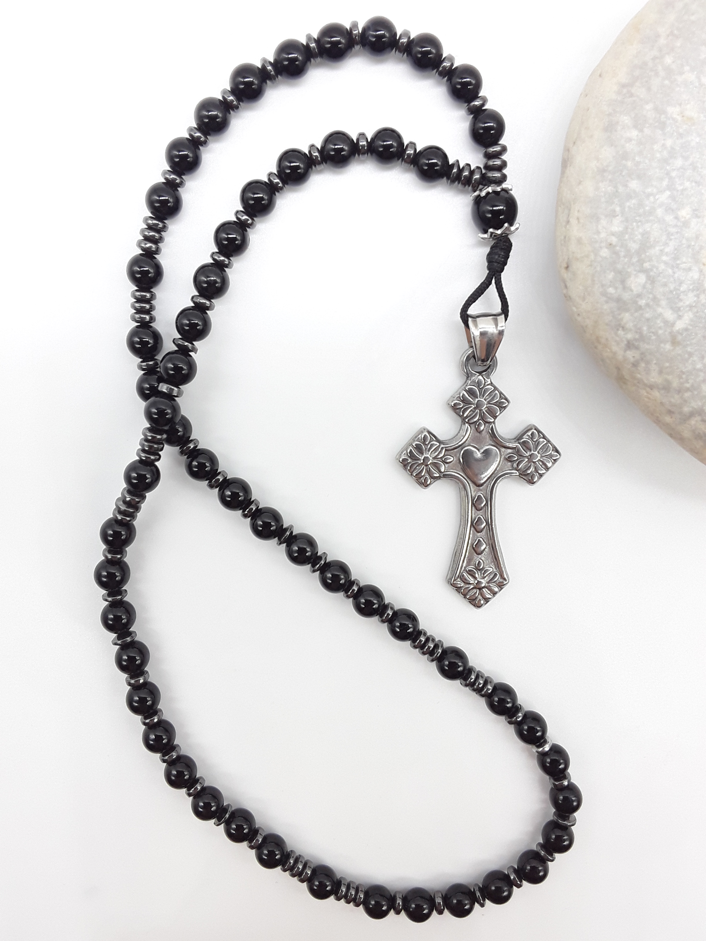 Black Onyx and Hematite Orthodox Rosary with stainless steel cross beside natural stone surface by Polmadeva.