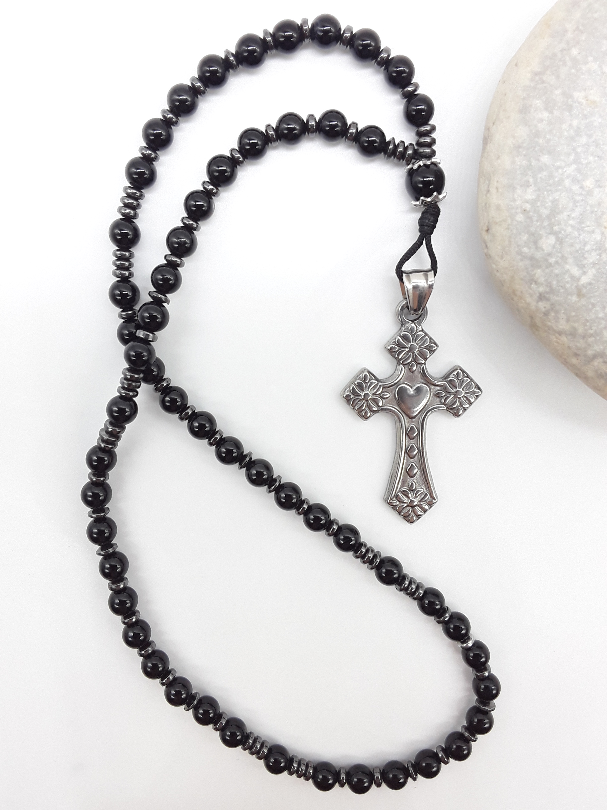 Black Onyx and Hematite Orthodox Rosary with stainless steel cross beside natural stone surface by Polmadeva.
