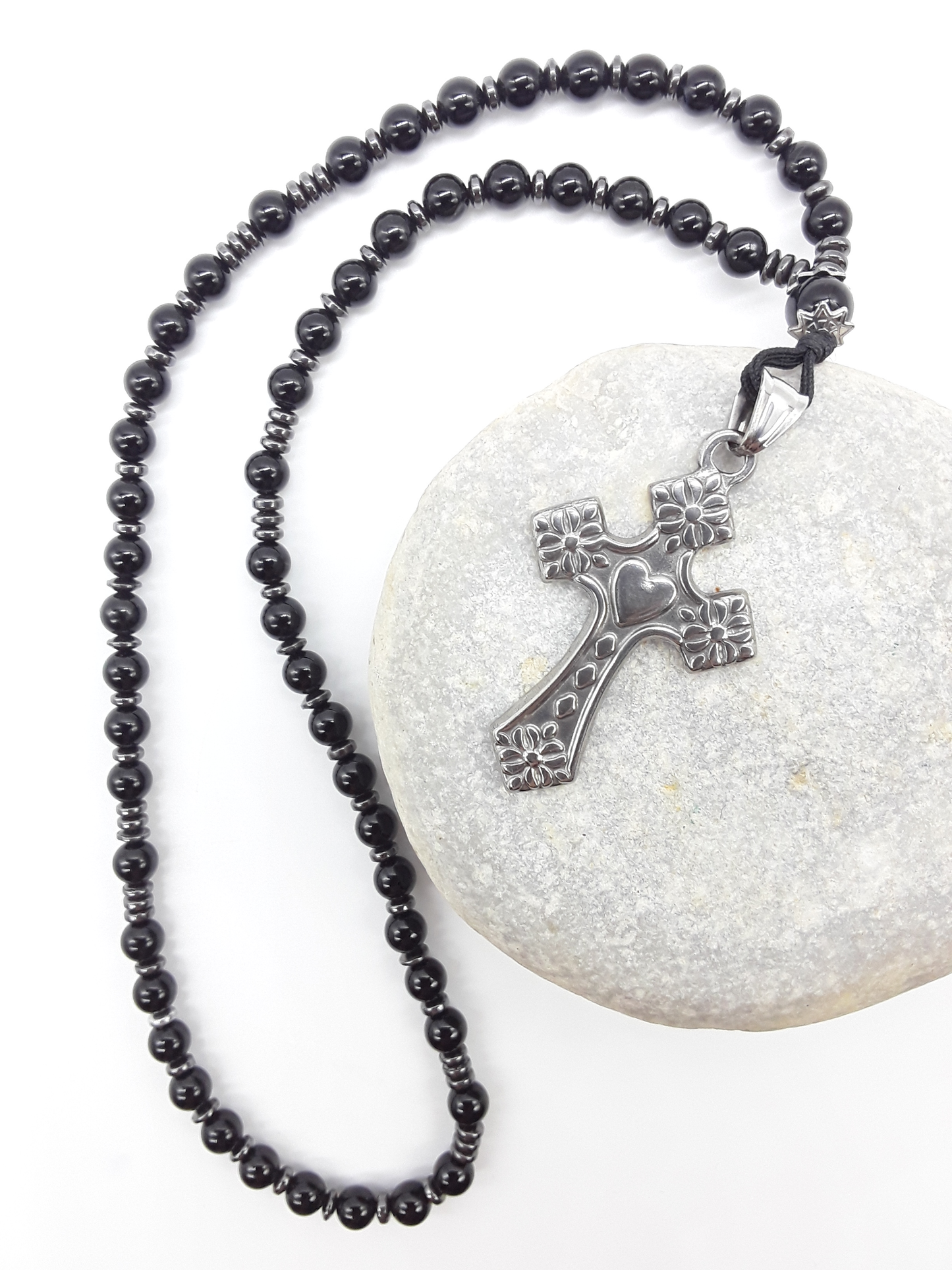 Black Onyx and Hematite Orthodox Rosary with stainless steel cross resting on natural stone surface by Polmadeva.