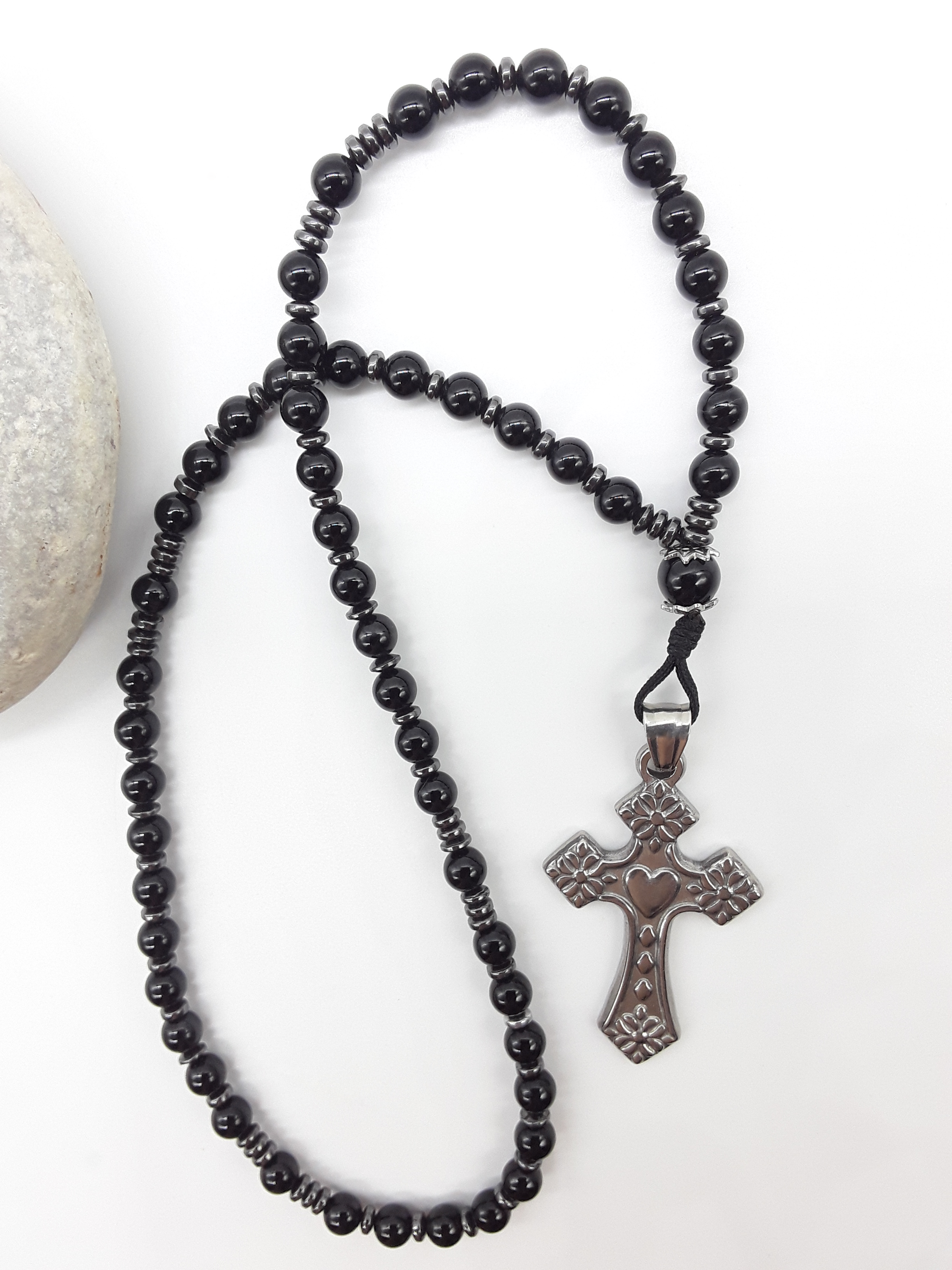 Black Onyx and Hematite Orthodox Rosary with stainless steel cross beside natural stone surface by Polmadeva.