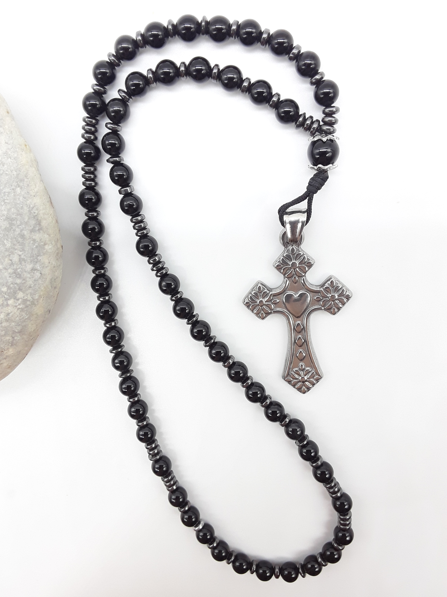 Black Onyx and Hematite Orthodox Rosary with stainless steel cross beside natural stone surface by Polmadeva.