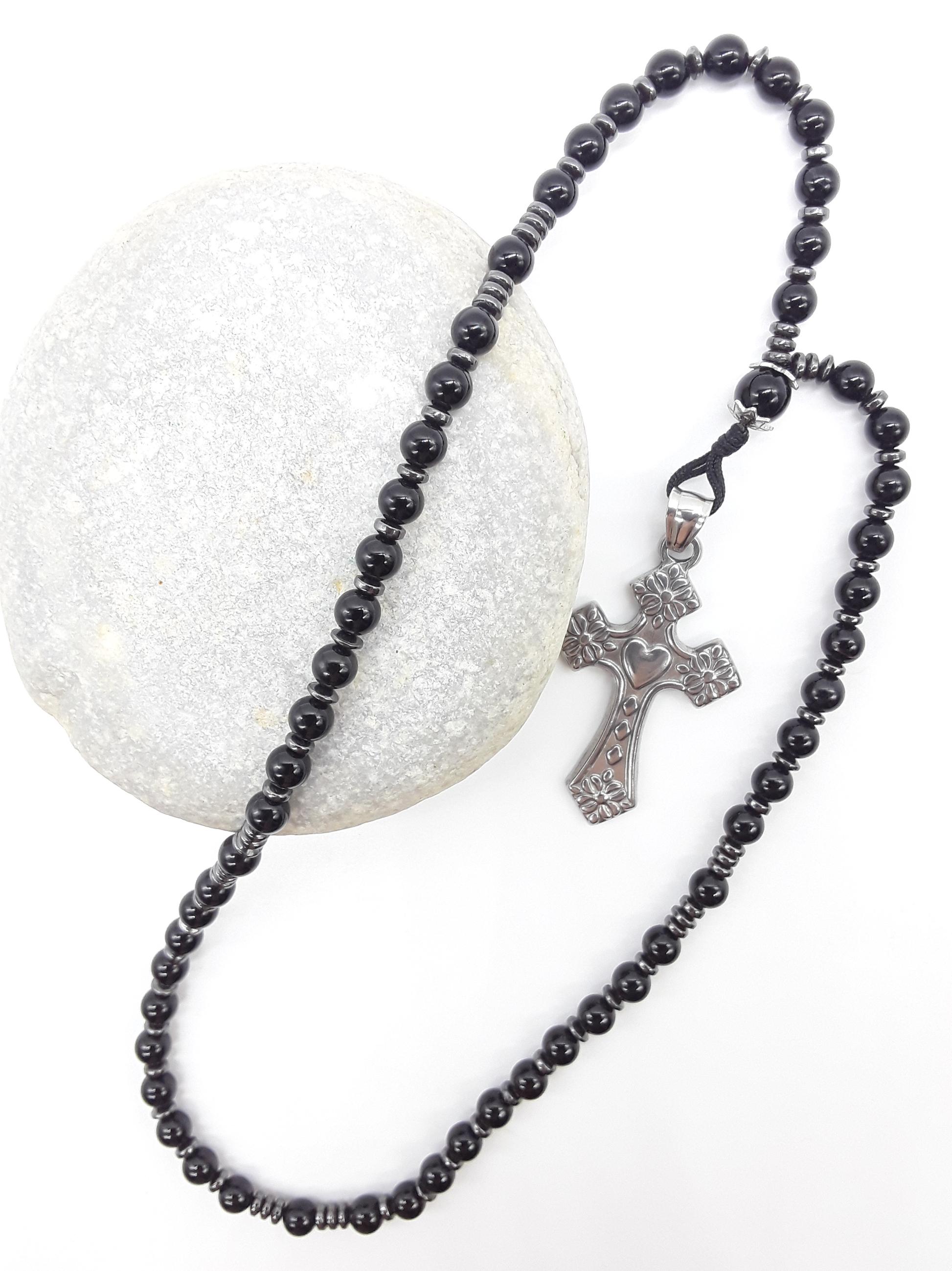 Black Onyx and Hematite Orthodox Rosary with stainless steel cross resting on natural stone surface by Polmadeva.