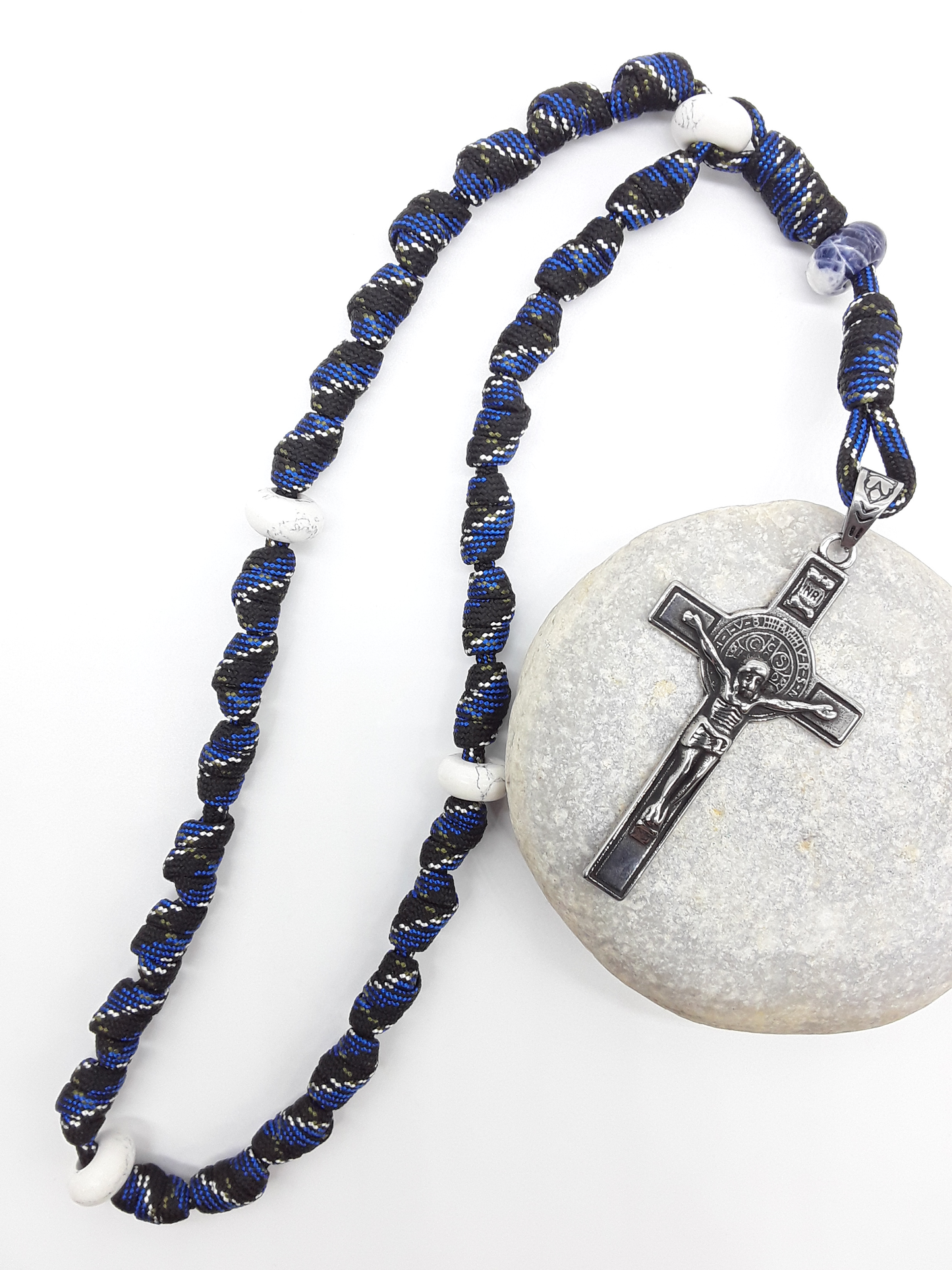 The Steady Witness Saint Benedict Anglican Rosary by Polmadeva with hand-knotted black and blue paracord, Howlite elements, and Saint Benedict Crucifix on stone.