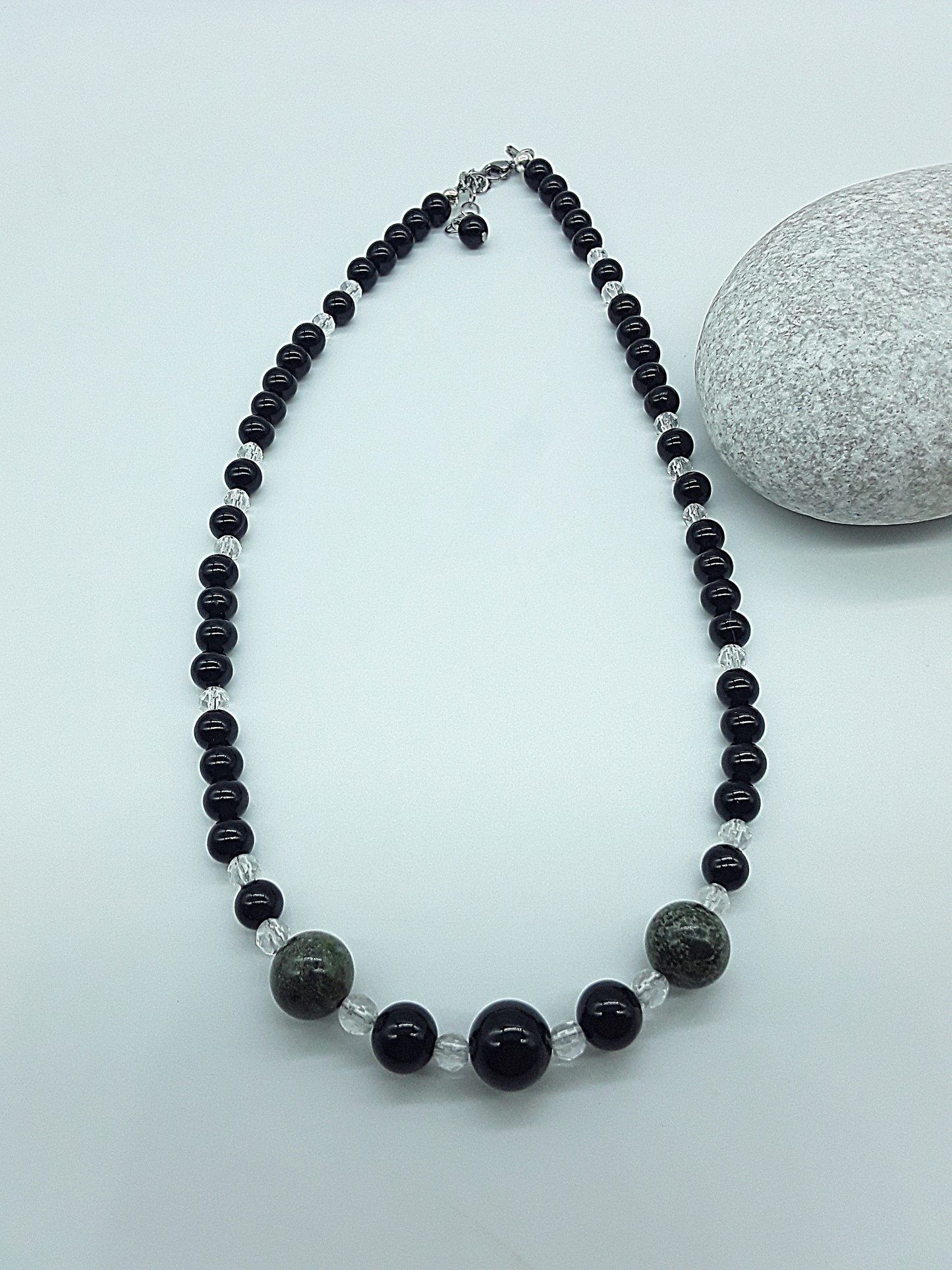 Handcrafted Stillwatch Guardian Necklace with black onyx beads, natural quartz crystal and dragon blood stone on neutral background