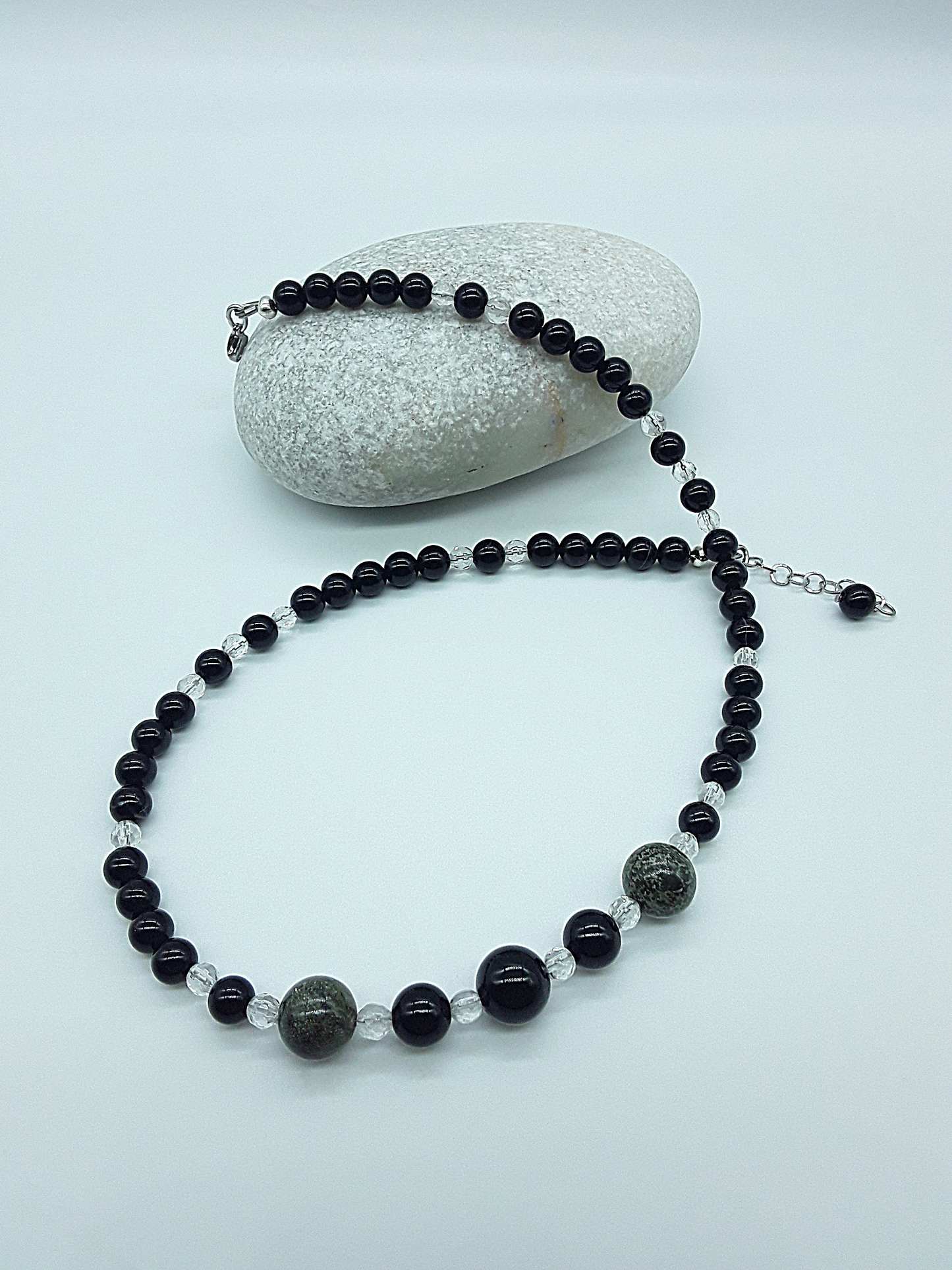 Stillwatch Guardian Necklace detail showing layered black onyx beads and dragon blood stone centerpiece