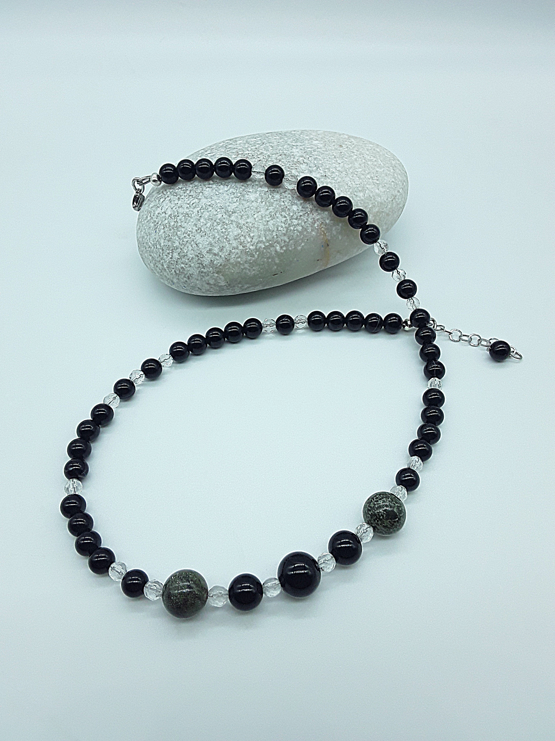 Stillwatch Guardian Necklace detail showing layered black onyx beads and dragon blood stone centerpiece