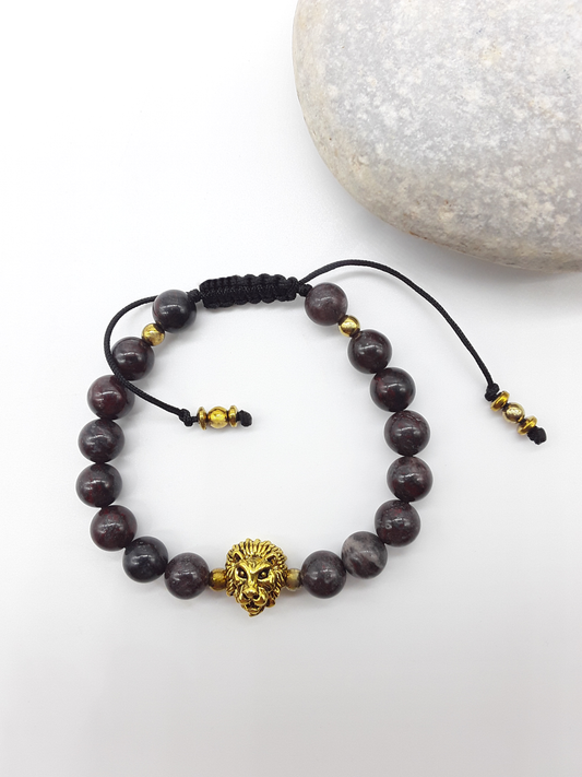 Bloodstone beaded lion bracelet placed beside natural stone elements