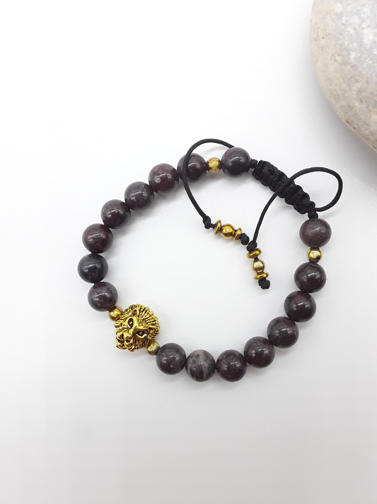 Bloodstone beaded lion bracelet placed beside natural stone elements