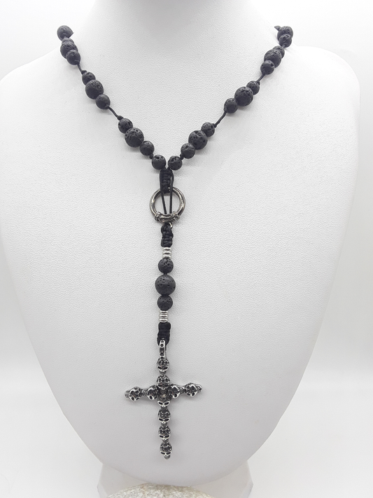 Catholic rosary in lava stone with skull crucifix displayed on mannequin bust
