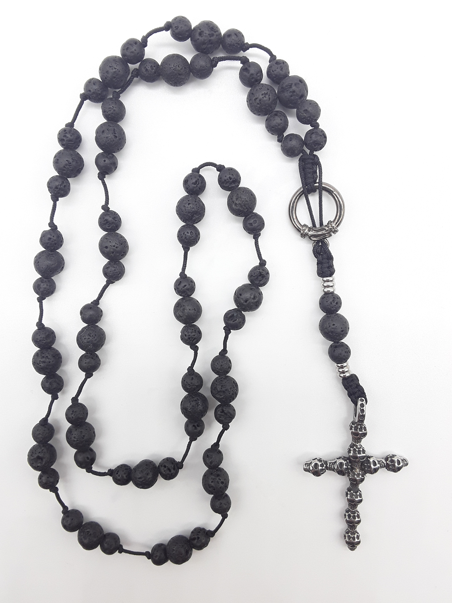 Handcrafted Catholic lava stone rosary with stainless steel skull crucifix on white background