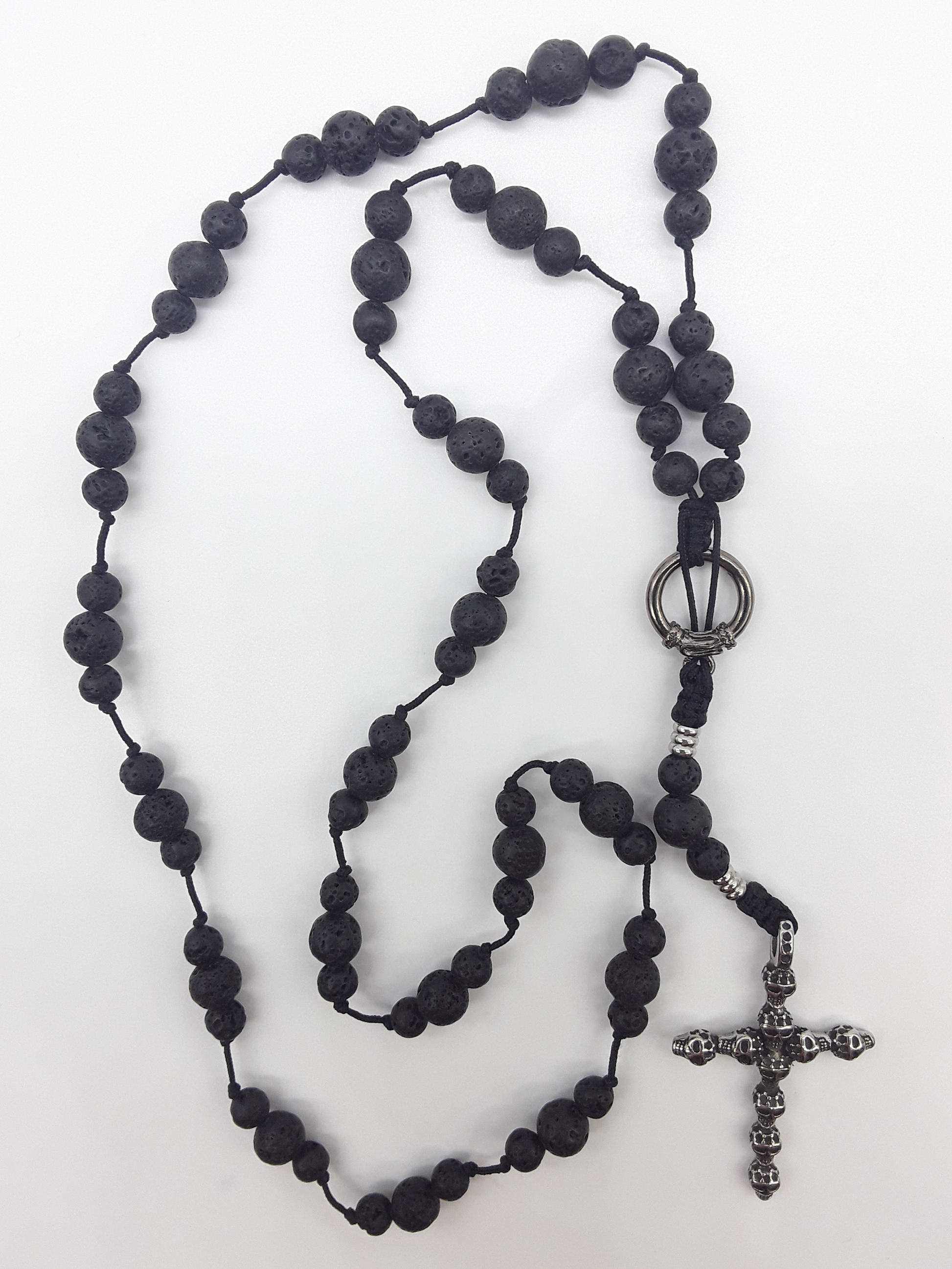 Handcrafted Catholic lava stone rosary with stainless steel skull crucifix on white background