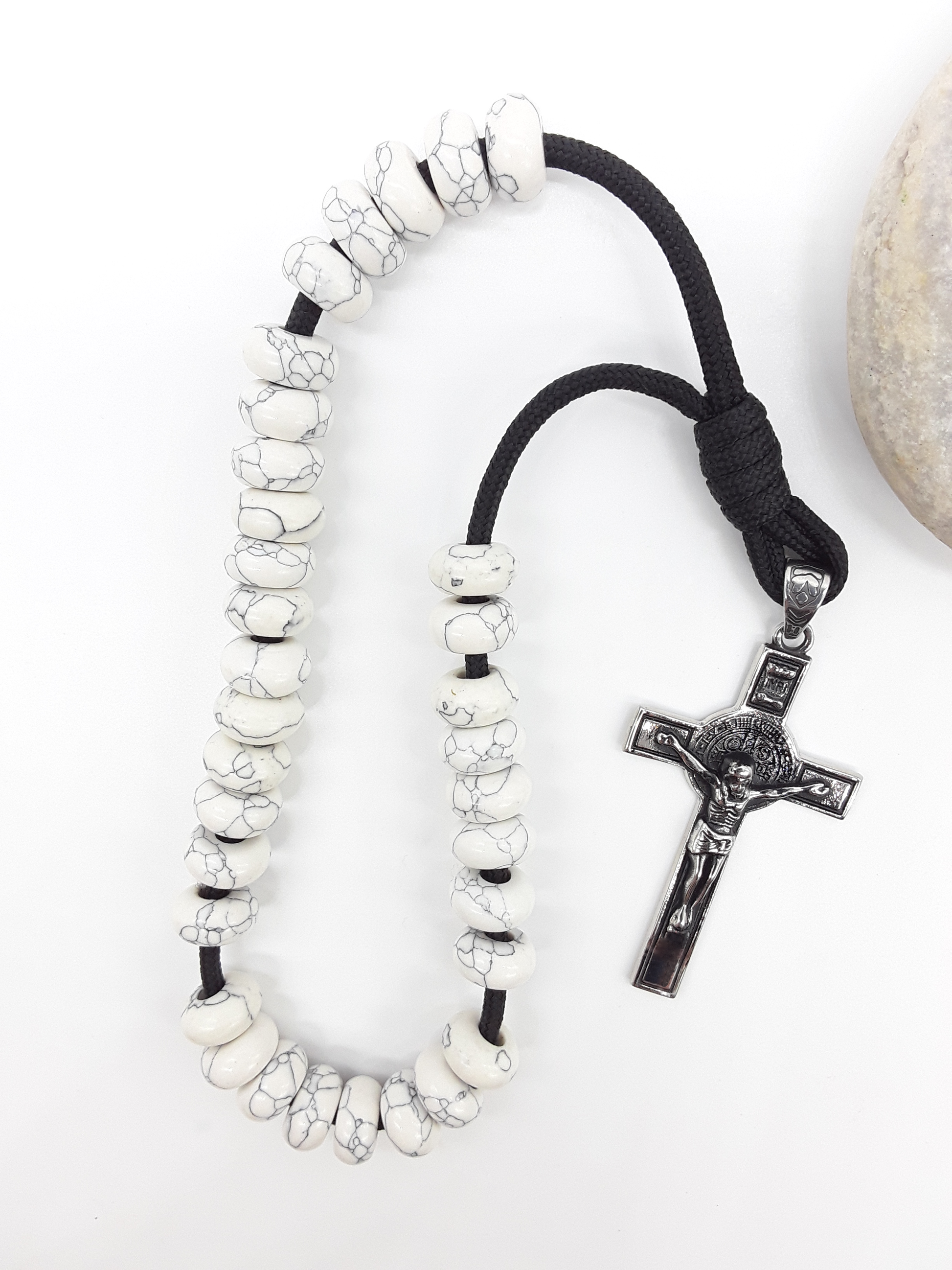 Howlite Paracord Orthodox Rosary with stainless steel crucifix beside natural stone surface by Polmadeva.