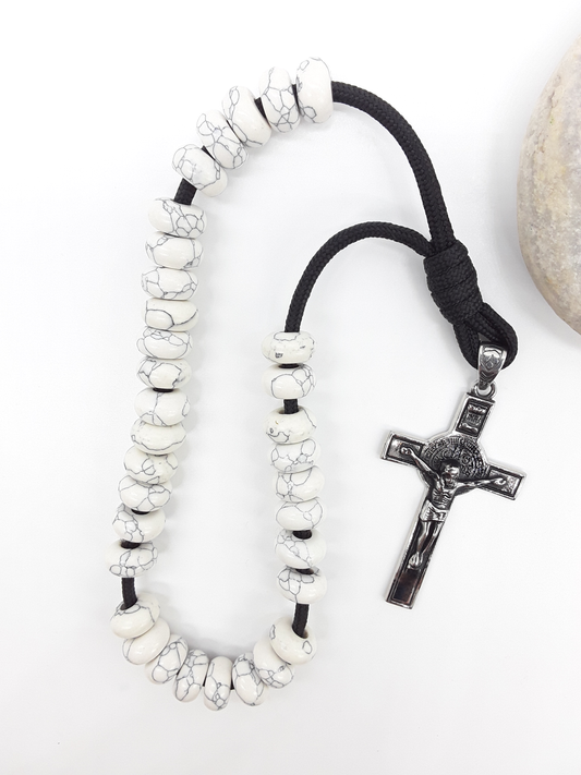 Howlite Paracord Orthodox Rosary with stainless steel crucifix beside natural stone surface by Polmadeva.