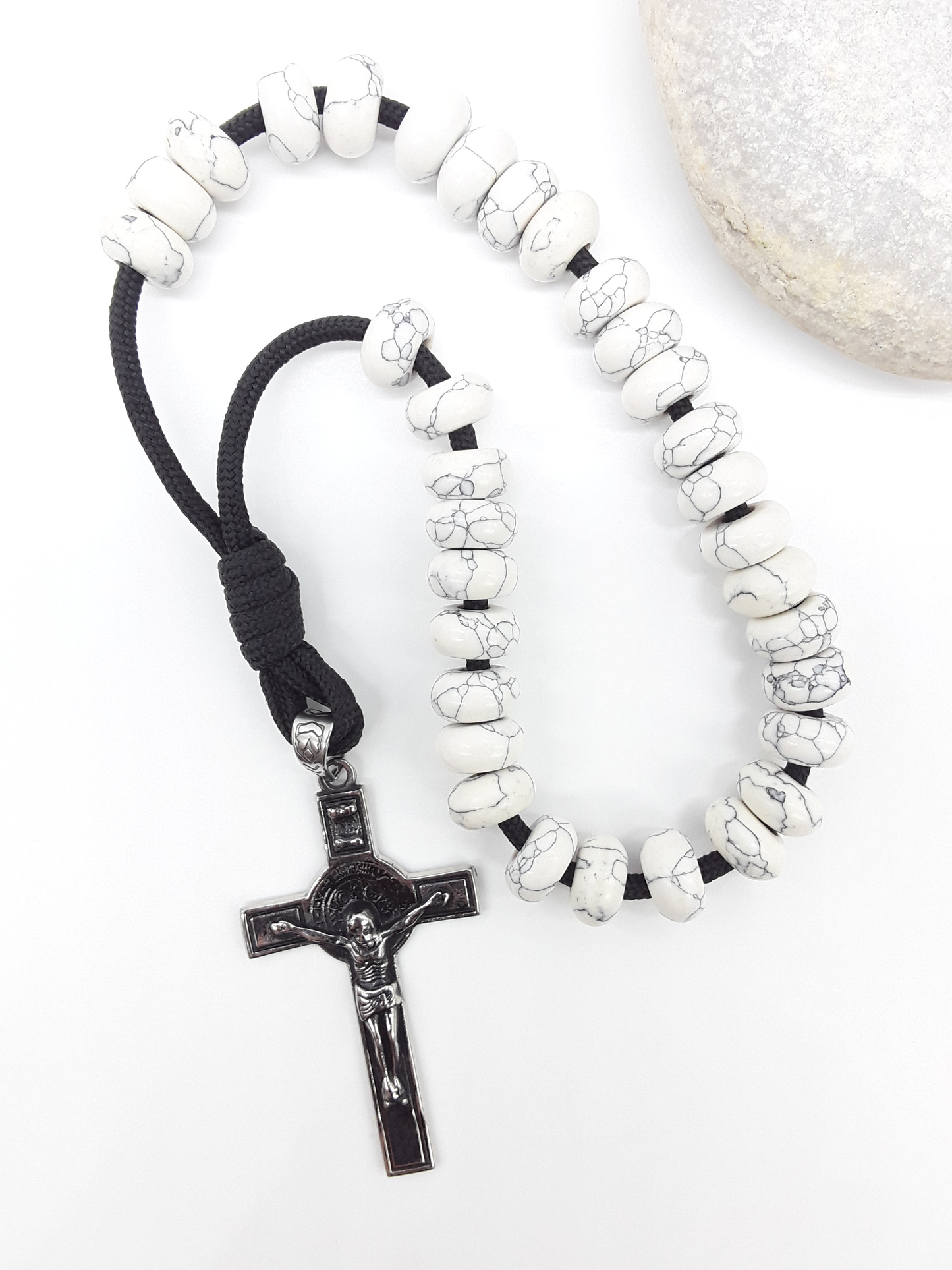 Howlite Paracord Orthodox Rosary with stainless steel crucifix beside natural stone surface by Polmadeva.
