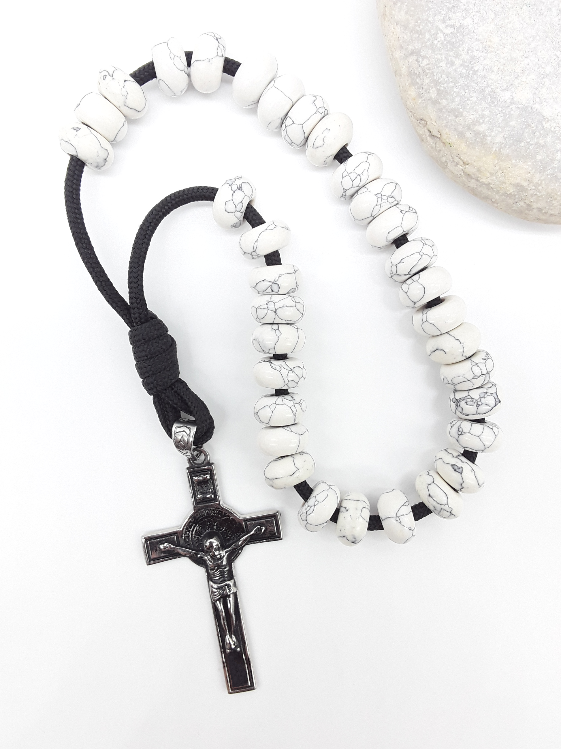 Howlite Paracord Orthodox Rosary with stainless steel crucifix beside natural stone surface by Polmadeva.