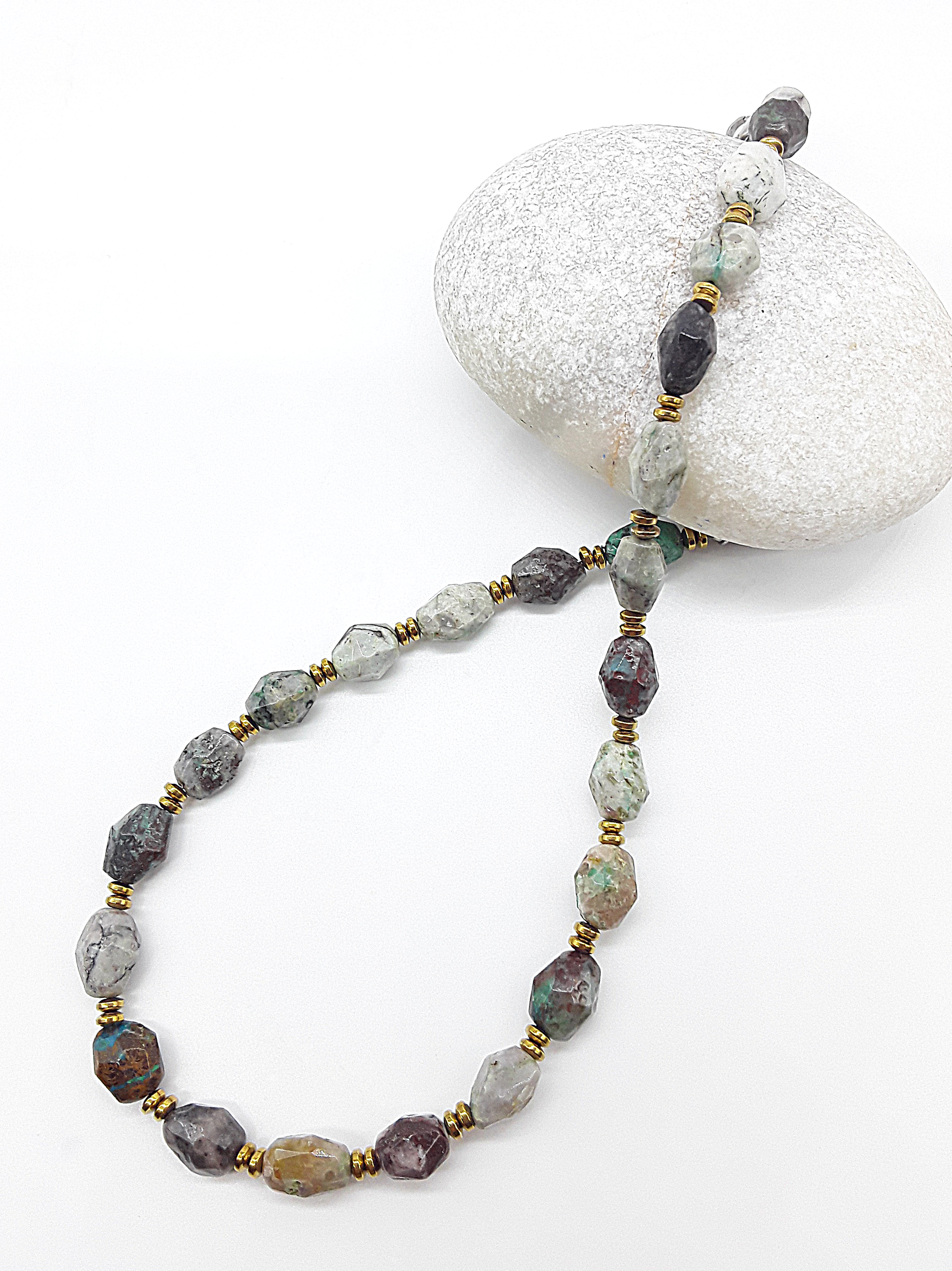 Necklace with multicolored beads on a white stone background