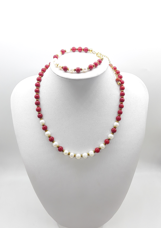 Where Grace Begins coral, freshwater pearl and hematite necklace with matching bracelet displayed on a jewelry bust by Polmadeva