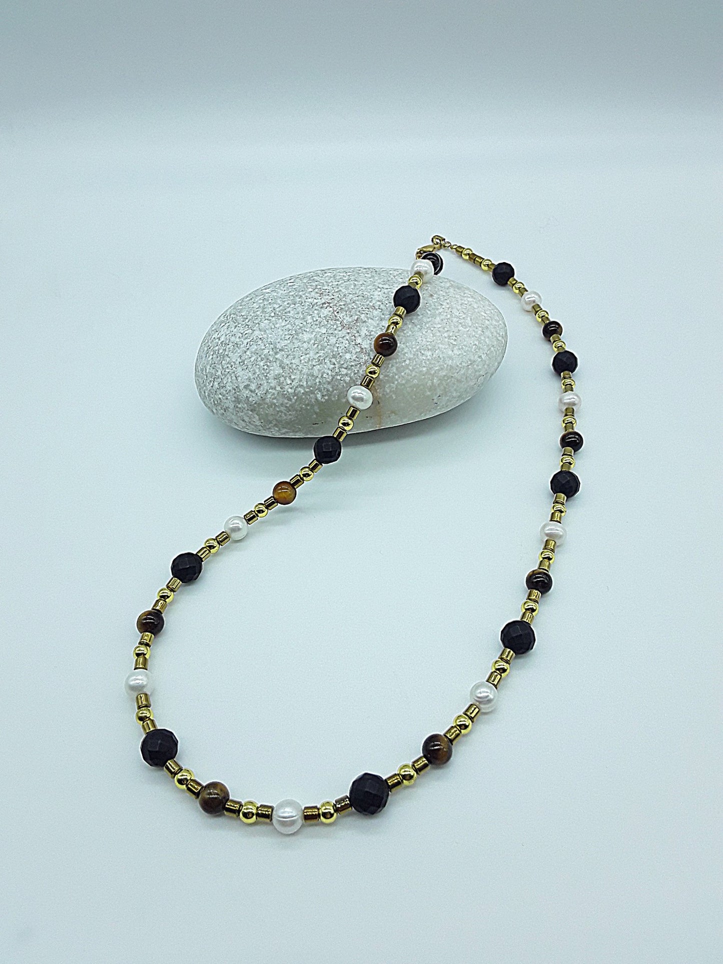 The Guardian Pearl Necklace by Polmadeva – pearl, onyx, tiger’s eye and hematite necklace symbolizing serenity, grounding, and protection