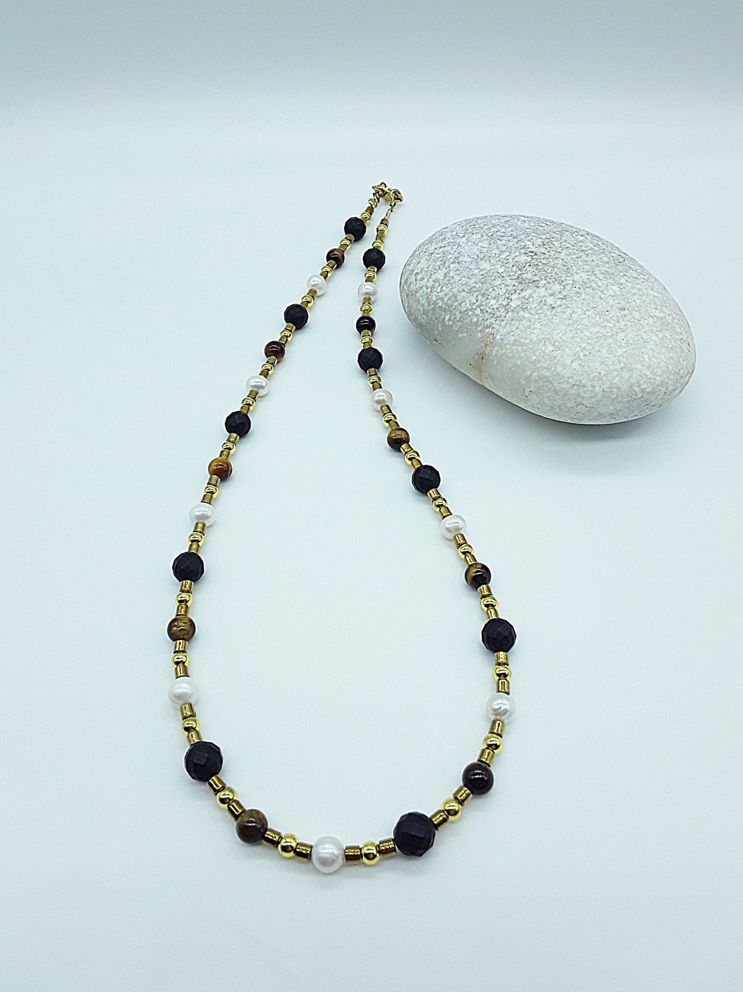 The Guardian Pearl Necklace by Polmadeva – pearl, onyx, tiger’s eye and hematite necklace symbolizing serenity, grounding, and protection