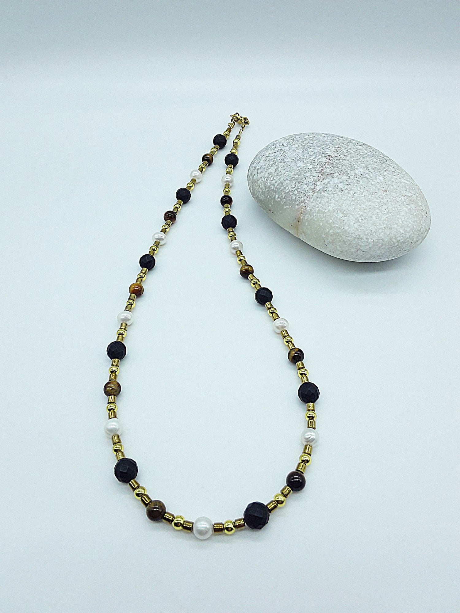 The Guardian Pearl Necklace by Polmadeva – pearl, onyx, tiger’s eye and hematite necklace symbolizing serenity, grounding, and protection